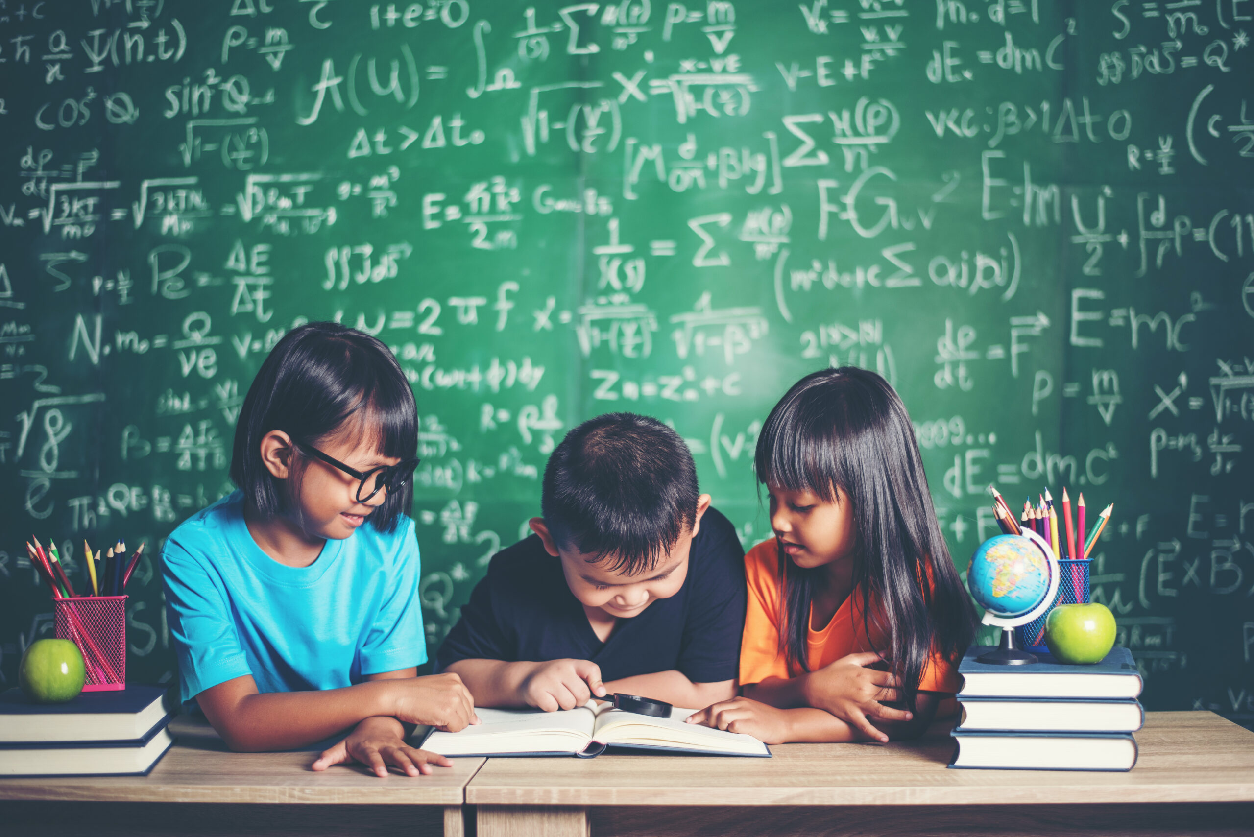 pupils  reading a book in the classroom.